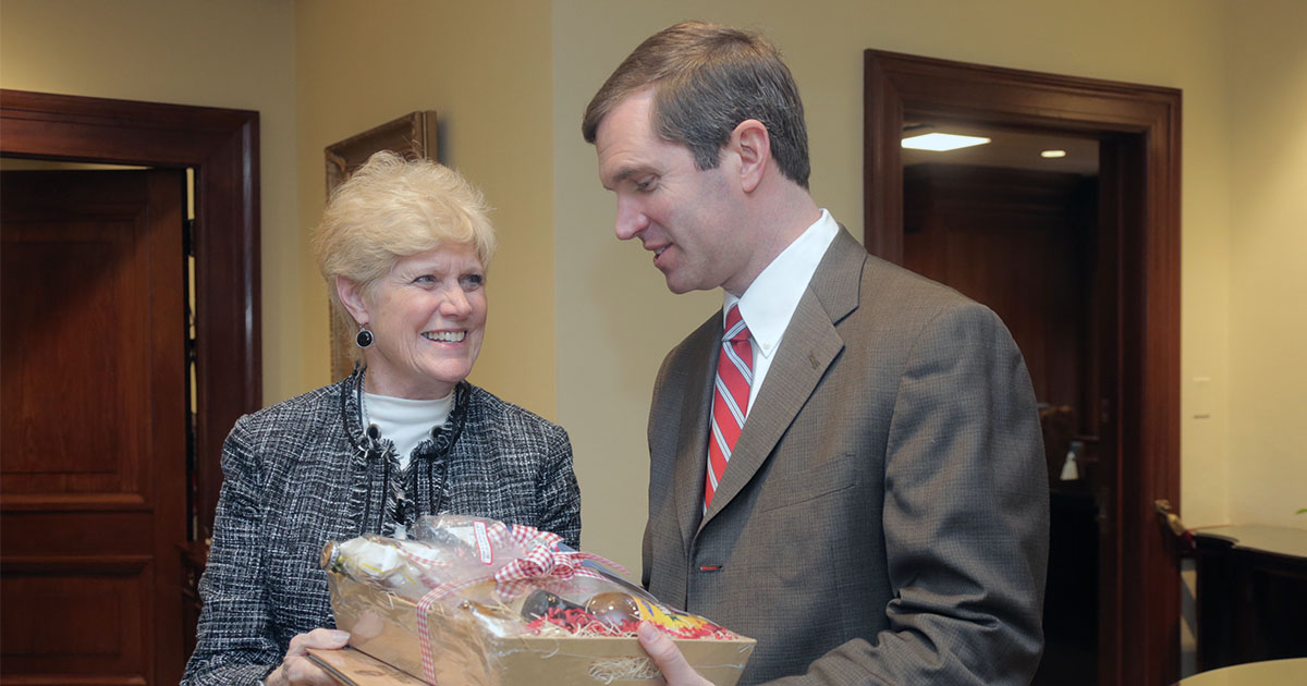 KFB Women's Advisory Committee Chair Judy Hayden gives Kentucky Governor Andy Beshear a basket of Kentucky Proud agriculture products during KFB Legislative Drive-In and Food Check-Out Day