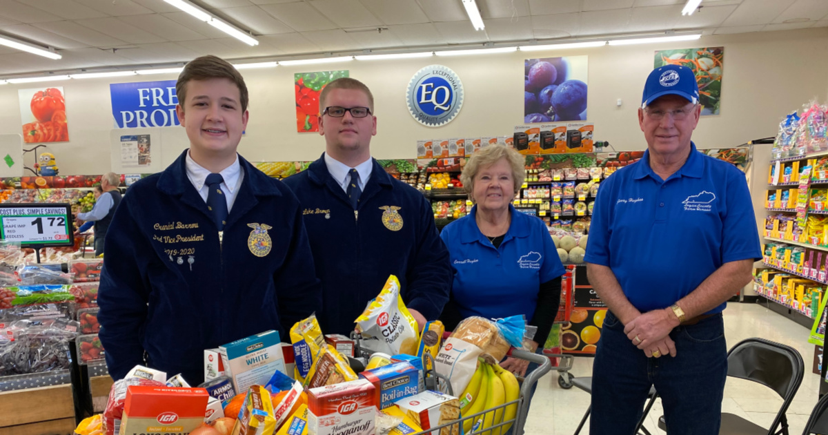 Crandal Barrow, Luke Brown, Carrell and Jerry Hughes celebrate Food Check-Out Day at the Russellville PRice Less IGA grocery store.