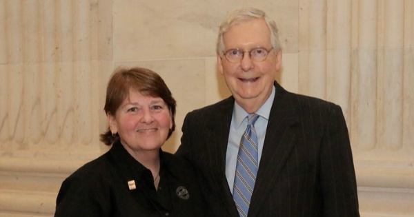 Marion County Farm Bureau Women's Committee Chair Peggy Downs poses with U.S. Senate Majority Leader Mitch McConnell at the 2020 Kentucky Farm Bureau Congressional Tour.
