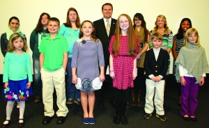 Agriculture Commissioner James Comer honored the statewide poster winners in the Kentucky Department of Agriculture’s Poster and Essay Contest during the Kentucky Agriculture Day luncheon March 27 in Frankfort. Statewide winners in each grade received $100 and an Honorary Commissioner of Agriculture certificate. Pictured are, from left: front row — Cadence Johnson, kindergarten, Fayette County; Jacob DeFevers, fourth grade, Barren County; Zoe Barker, third grade, Daviess County; Anna Avery, sixth grade, Hart County; Benjamin Wheat, first grade, Fayette County; Elizabeth Johnson, second grade, Warren County; back row — Heather Bensinger, eighth grade, Mercer County; Emily Jeter, 10th grade, Metcalfe County; Anna Lee, ninth grade, Metcalfe County; Commissioner Comer; Taylor DeWeese, 12th grade, Metcalfe County; Allison Davis, 11th grade; Mercer County; and Rebekah Masih, fifth grade, Boone County. (Kentucky Department of Agriculture photo)