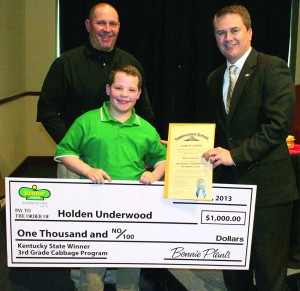 Holden Underwood of Cox's Creek, center, receives a $1,000 ceremonial check and an Honorary Commissioner of Agriculture certificate from Agriculture Commissioner James Comer, right, and Michael Morgan of Bonnie Plants as the Kentucky winner of the Bonnie Plants Third Grade Cabbage Contest during the Kentucky Agriculture Day luncheon March 27 in Frankfort. Holden grew a cabbage that weighed 20.5 pounds. (Kentucky Department of Agriculture photo)