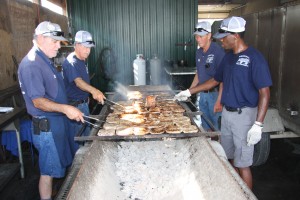 Jeff Schum, Carl Russell, Tom Watson, and Larry Alvis cook chops for a recent event at the Kentucky Exposition Center.
