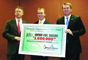 From left, U.S. Sen. Rand Paul, Kentucky State Treasurer Todd Hollenbach, and state Agriculture Commissioner James Comer with the commemorative check. (Kentucky Department of Agriculture photo)
