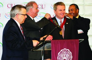 Agriculture Commissioner James Comer, second from right, is presented the Campbellsville University Leadership Award by, from left: Dr. John Chowning, vice president for church and external relations and executive assistant to the president for CU; university President Michael V. Carter; and Dr. Joseph Owens, chairperson of the Campbellsville University Board of Trustees. (Campbellsville University photo by Drew Tucker)