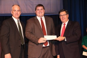 Cameron Edwards (center), winner of the 2014 Discussion Meet at Kentucky Farm Bureau’s annual meeting in Louisville, is presented with his award by David S. Beck, KFB Executive Vice President (right), and Scott Christmas, KFB Director of Agricultural Education, Women and Young Farmer Programs (left).