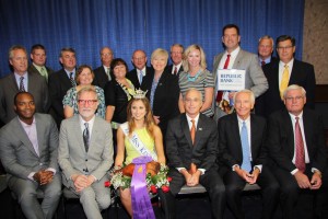 Miss Kentucky 2014, Ramsey Carpenter (holding the Grand Champion Ham) sits on the front row with winning bidders (left to right) Ryan Bridgeman of Bridgeman Foods, Steve Wilson of Hermitage Farms and Steve Trager of Republic Bank & Trust Company after placing the record-setting $2 million bid. Governor Steve Beshear and Kentucky Farm Bureau President Mark Haney complete the front row and are joined in the second row by Louisville Mayor Greg Fischer and numerous representatives from Kentucky Farm Bureau and Republic Bank.