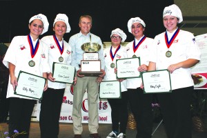 Agriculture Commissioner James Comer, center, presents the 2015 Farm to School Junior Chef championship trophy to members of the Anderson County High School “Culinary Cats:” from left, Ally Hayes, Gracie Inabnitt, Mary Grace Bamburger, Christina Montgomery, and Abby Coyle. (Kentucky Department of Agriculture photo)